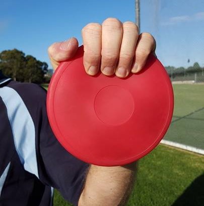 Image showing discus gripped with fingers too far over edge