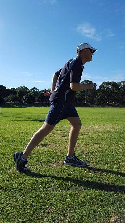 Picture of an individual standing in the "set" position with a straight back leg