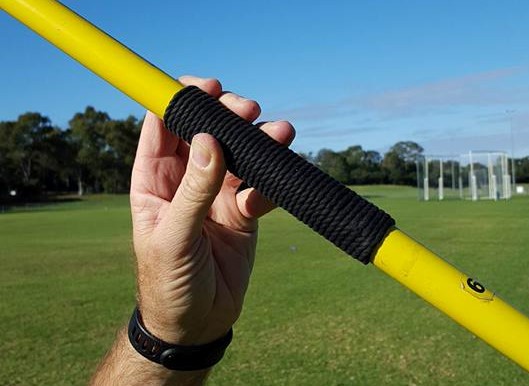 A javelin held incorrectly in the fingertips