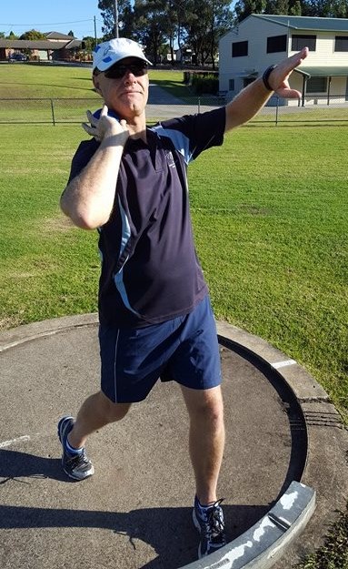 Shot putter with their elbow leading the shot,