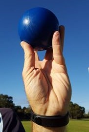 Shot being incorrectly held in the finger tips.