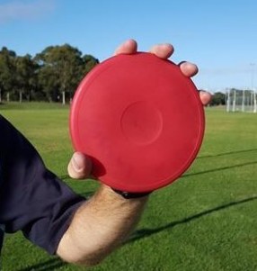 Discus held with thumb incorrectly over the edge.